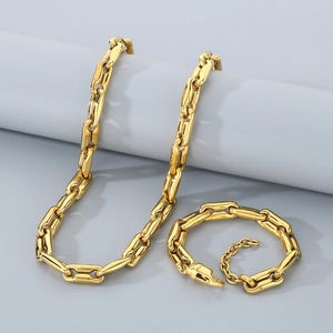 Close-up of polished gold-tone link necklace and bracelet set with lobster clasp