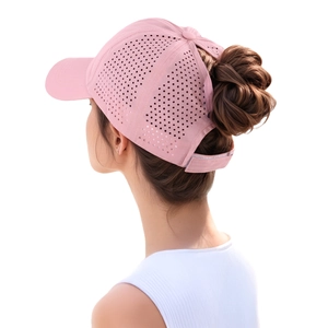 Detail of pink ponytail baseball cap showing laser-cut vents and high bun opening