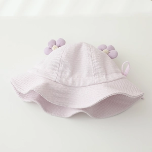 Close-up of light purple baby sun hat with soft fabric texture and 3D flower detail