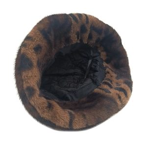 Detail view of leopard print plush bucket hat showing quilted lining and adjustable ribbon