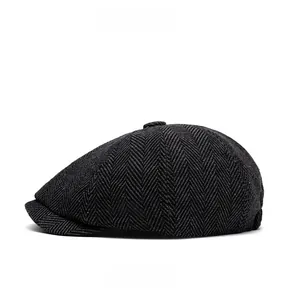 Side view detail of a vintage grey herringbone newsboy cap made of wool tweed fabric