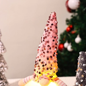 Detail of pink sequin glow Christmas gnome with LED light and plush knitted fabric texture