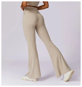 Detail view of high waisted flared yoga pants featuring ruched waistband in light beige