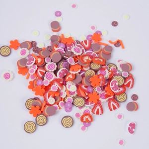 Colorful polymer clay slices including fruit and floral patterns for DIY slime making