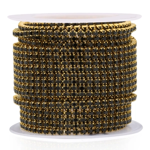 Golden stainless steel claw chain with black rhinestones on a white spool for DIY jewelry