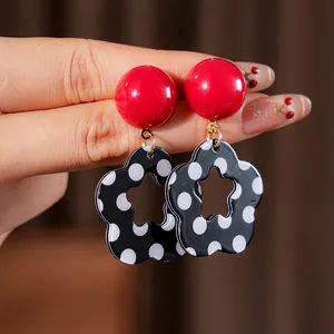 Retro red resin ball earrings with black and white polka dot flower charms and gold hoops