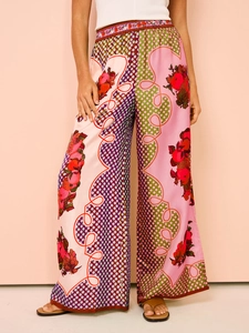 Detail of floral geometric print wide-leg trousers with silky satin finish and high waist