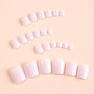 Set of 24 soft pink glossy press-on toenails for a professional pedicure finish