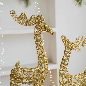 Golden iron Christmas reindeer ornament with hollow wire design and glittering finish