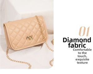 Close-up of beige quilted texture and golden CC rotary metal lock on chain bag