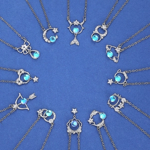 Zodiac pendant necklaces with blue moonstone and diamonds on a blue background