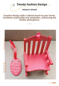 Detail of red wooden memorial rocking chair with engraved plaque and festive red ribbon