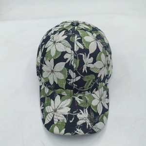 Detailed top view of a baseball cap with white floral patterns and green leaves
