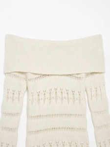 Detailed view of off-the-shoulder cream knit sweater with geometric hollow patterns