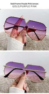 Detail of gold metal frame sunglasses with V-shaped bridge and purple gradient lenses