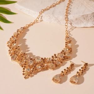 Luxurious gold-tone V-shaped jewelry set with champagne teardrop crystals and drop earrings
