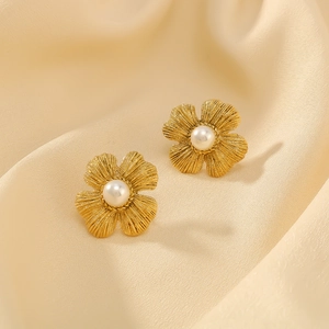 Vintage 18K gold-plated stainless steel flower earrings with pearls on silk background