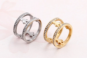 Detailed view of hollow figure rings in gold and silver with white zircon pavé setting