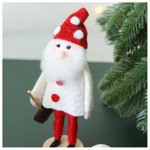 Detailed view of handmade wool felt Christmas elf with red polka dot hat and wooden base