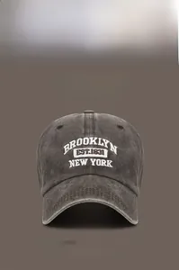 Close-up of vintage washed cotton baseball cap with Brooklyn embroidery and metal buckle