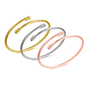 Detailed view of cable twisted wire bangles in gold, silver and rose gold metal finishes