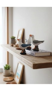 Detailed resin seagull figurines on wood shelf for coastal style home decor accents