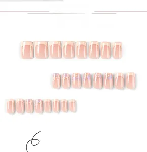 Macro view of short French nail tips with purple and orange floral designs on nude base