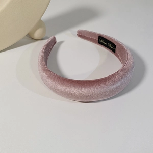Close-up of pink velvet padded headband showing soft texture and premium fabric finish