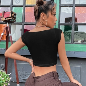 Macro shot of black ribbed knit fabric and square neck detail on a slim-fit crop top