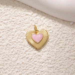 Exquisite gold-plated heart pendant with pink enamel and radiant textured metal border