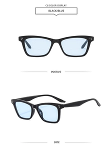 Detail view of black square sunglasses with light blue lenses and silver rivet accents