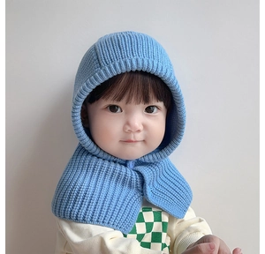 Detailed knit texture and button closure on blue infant balaclava winter hood