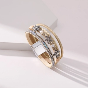 Detail view of multi-layer wrap bracelet featuring sea turtle and starfish charms with crystals