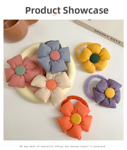 Close-up of colorful 3D fabric sunflower hair ties on a ceramic plate for girls