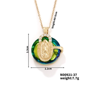 Detail view of gold-plated portrait pendant with green crystal and size dimensions