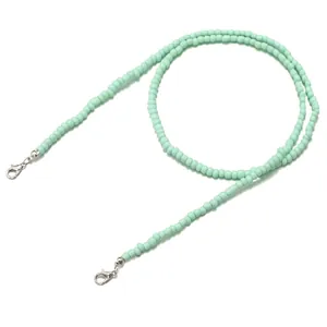 Detail of mint green beaded lanyard with silver lobster clasps for glasses or masks