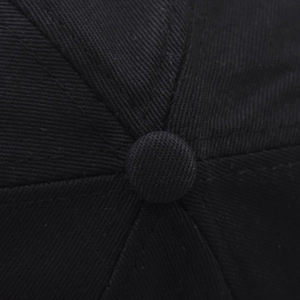 Detailed top view of a black cotton baseball cap showing the button and stitched seams