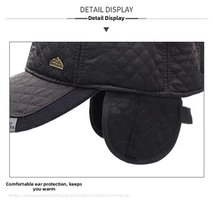 Detail view of winter quilted baseball cap with ear flaps and thermal lining
