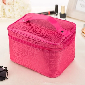 Close-up of pink satin makeup bag featuring textured fabric with GNEOZ OISGNE pattern
