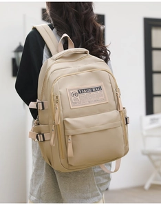 Side view of a khaki large-capacity school backpack with multiple utility pockets