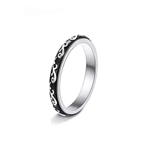 Macro detail of rotating stainless steel ring with black enamel and vine pattern