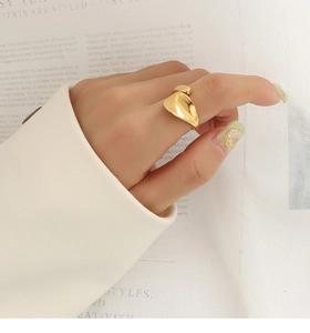 Macro detail of minimalist 18k gold geometric irregular ring with polished finish