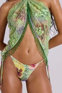 Detail of floral beaded tassels and sequin embroidery on green halter top and skirt