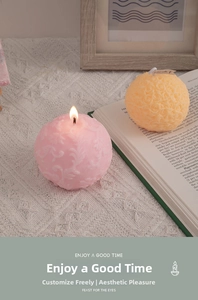 Close-up of decorative rose and leaf embossed scented candles on lace tablecloth