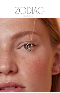 Close-up of a model wearing a gold S925 silver zodiac necklace with colorful crystals