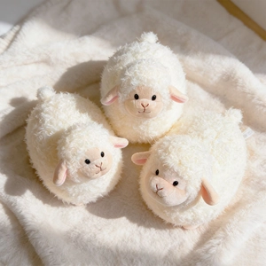 Three cute white plush lamb toys with curly faux wool on a matching soft rug