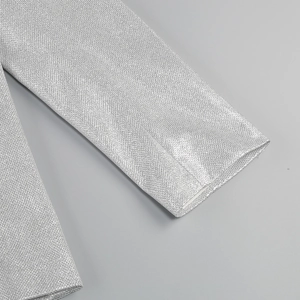 Detailed close-up of silver sequin fabric and cuff texture on a three-piece set