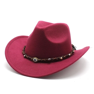 Detail of burgundy cowboy hat with woven band featuring an evil eye bead and metal accents