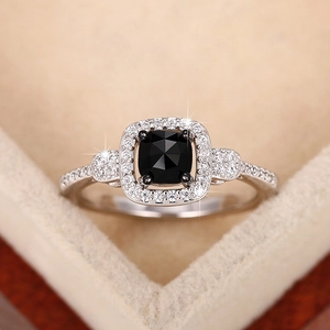 Elegant vintage square black gemstone ring with silver band and brilliant side stones