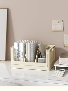 Detail of cream white foldable storage basket with books and stationery on desk